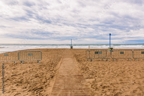 Beach closed in winter with a cloudy sky