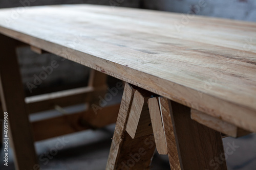 long large wooden table on legs in the room © Dana Keli