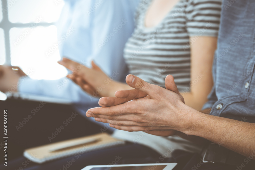 Business people clapping at meeting or conference, close-up of hands. Group of unknown businessmen and women in modern white office. Success teamwork, corporate coaching and applause concept Business people clapping at meeting or conference, close-up of hands. Group of unknown businessmen and women in modern white office. Success teamwork, corporate coaching and applause concept