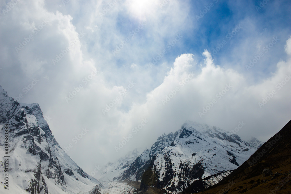 Low clouds cover the mountain peaks of the Himalayan Mountains.