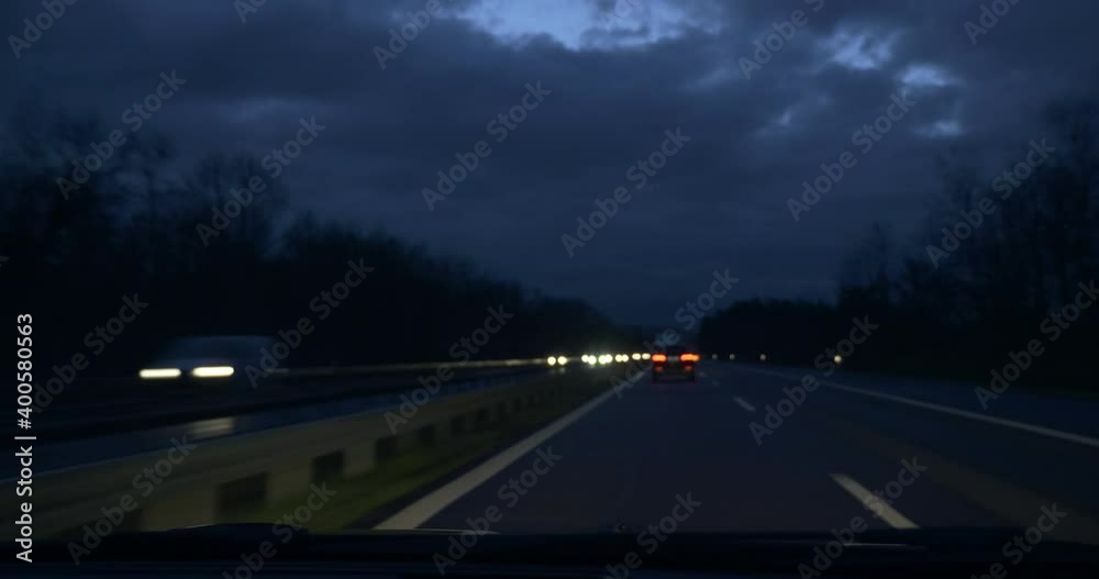 Driving Car on Highway at Night. Vehicle Overtakes Cargo Truck. SUV Windshield Hood POV. Heavy Traffic Driving Car on Highway at Night. Vehicle Overtakes Cargo Truck. SUV Windshield Hood POV. Heavy Traffic