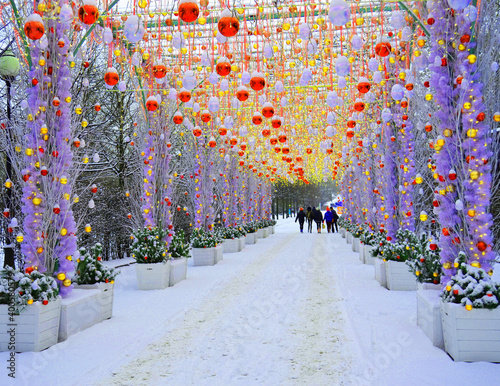 festive christmas tunnel of light with people