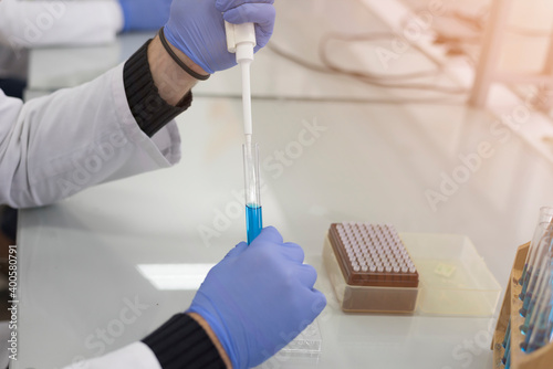 Scientist holding test tube or microscope in lab, finding treatment or vaccine for coronavirus infection. Covid-19, laboratory, and vaccine concept