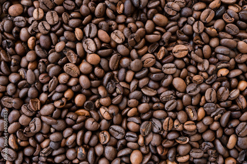 Fototapeta Naklejka Na Ścianę i Meble -  Flat lay with copy space, close-up view of some roasted coffee beans forming a natural pattern. Natural background.