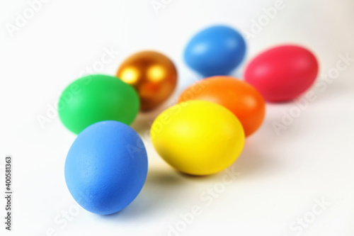 Bunch of colorful Easter eggs on the white surface, selective focus