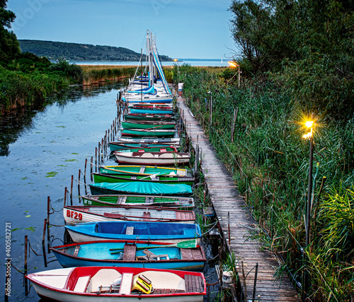 Sailboats in the harbor of Balatonfenyves, Hungary in dusk photo