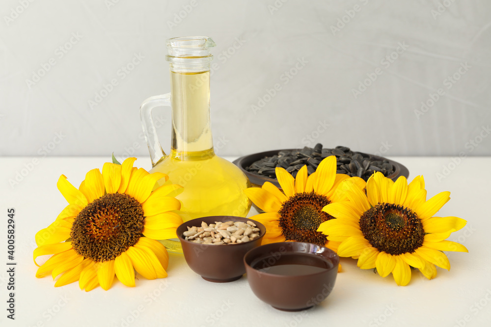 Composition with sunflower oil on white table Composition with sunflower oil on white table