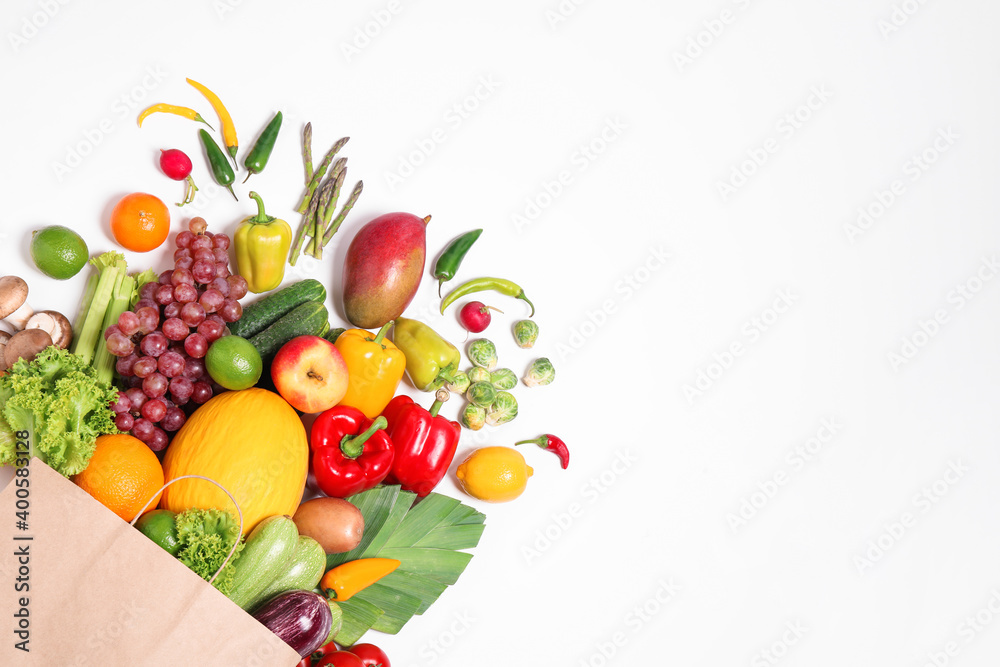 Paper bag with assortment of fresh organic fruits and vegetables on white background, top view Paper bag with assortment of fresh organic fruits and vegetables on white background, top view
