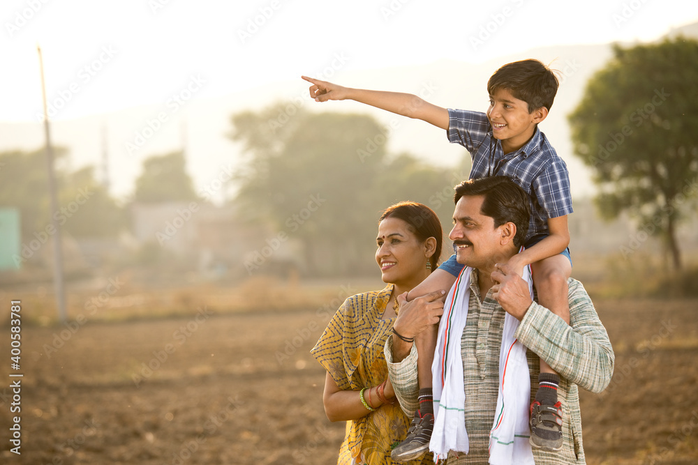 Happy rural Indian family on agricultural field Happy rural Indian family on agricultural field