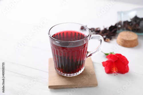 Delicious hibiscus tea on white wooden table