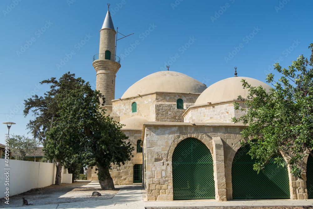 Hala Sultan Tekke or the Mosque of Umm Haram near with palm tree, a mosque and tekke complex on the west bank of Larnaca Salt Lake, in Larnaca, Cyprus