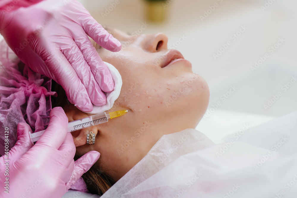 Cosmetic procedure for biorevitalization and removal of wrinkles for a young beautiful girl. Cosmetology