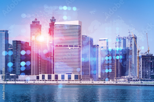 Skyscrapers of Dubai business downtown. International hub of trading and financial services. Social network icons hologram  concept of people connection. Double exposure. Dubai Canal waterfront.
