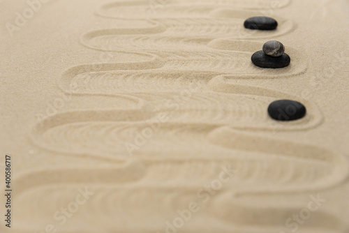 Zen sand garden meditation stone background with copy space. Stones and lines drawing in sand for relaxation. Concept of harmony, balance and meditation, spa, massage, relax. Set Sail Champagne color