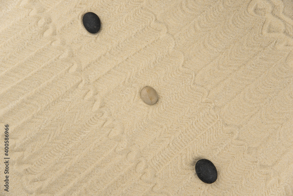 Zen sand garden meditation stone background with copy space. Stones and lines drawing in sand for relaxation. Concept of harmony, balance and meditation, spa, massage, relax. Set Sail Champagne color Zen sand garden meditation stone background with copy space. Stones and lines drawing in sand for relaxation. Concept of harmony, balance and meditation, spa, massage, relax. Set Sail Champagne color