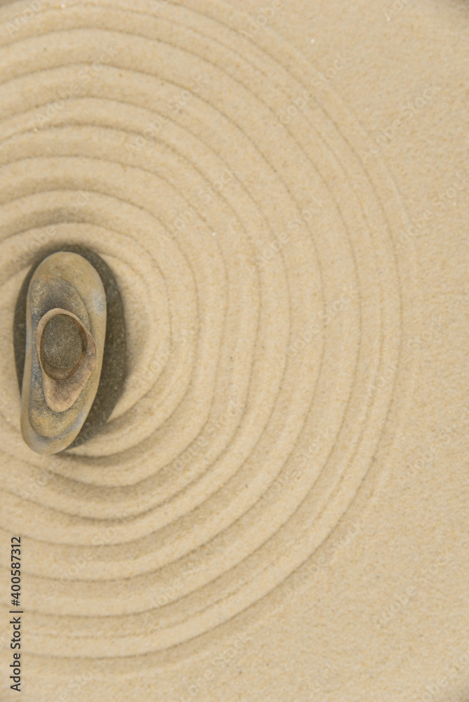 Naklejka premium Zen sand garden meditation stone background with copy space. Stones and lines drawing in sand for relaxation. Concept of harmony, balance and meditation, spa, massage, relax. Set Sail Champagne color