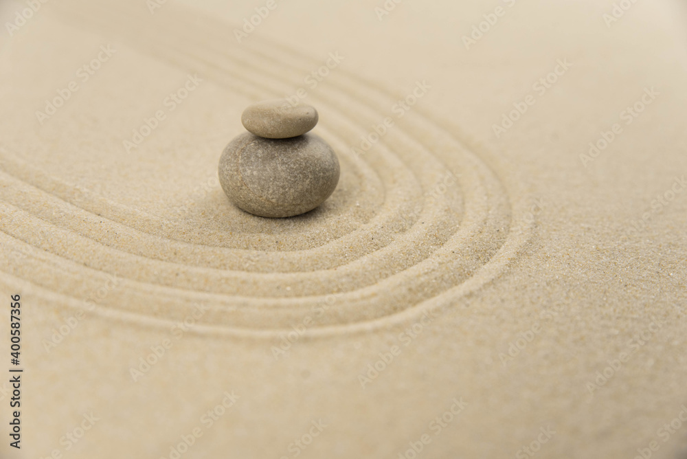 Obraz premium Zen sand garden meditation stone background with copy space. Stones and lines drawing in sand for relaxation. Concept of harmony, balance and meditation, spa, massage, relax. Set Sail Champagne color