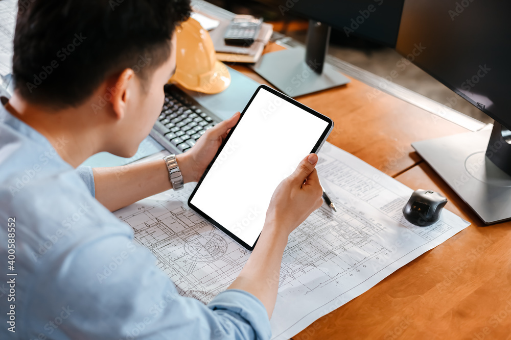 Architect reading building and drawing outlay construction plan as ...