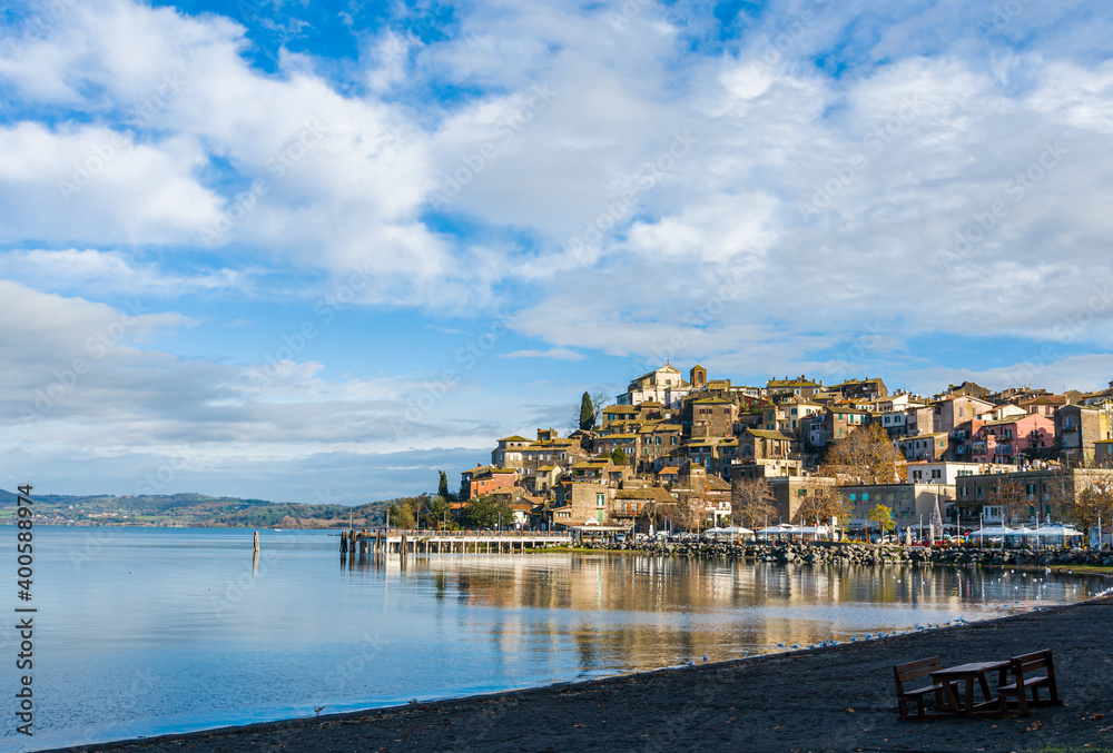 Italian city of Anguillara viewed from a lake beach