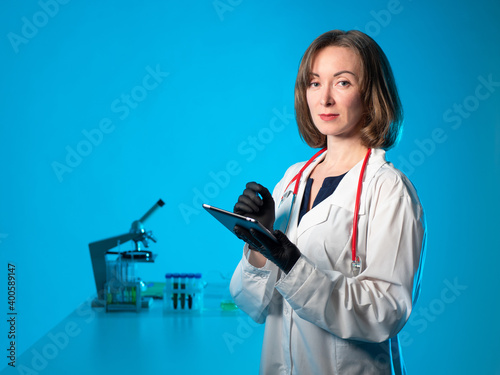 A female doctor with a tabl...