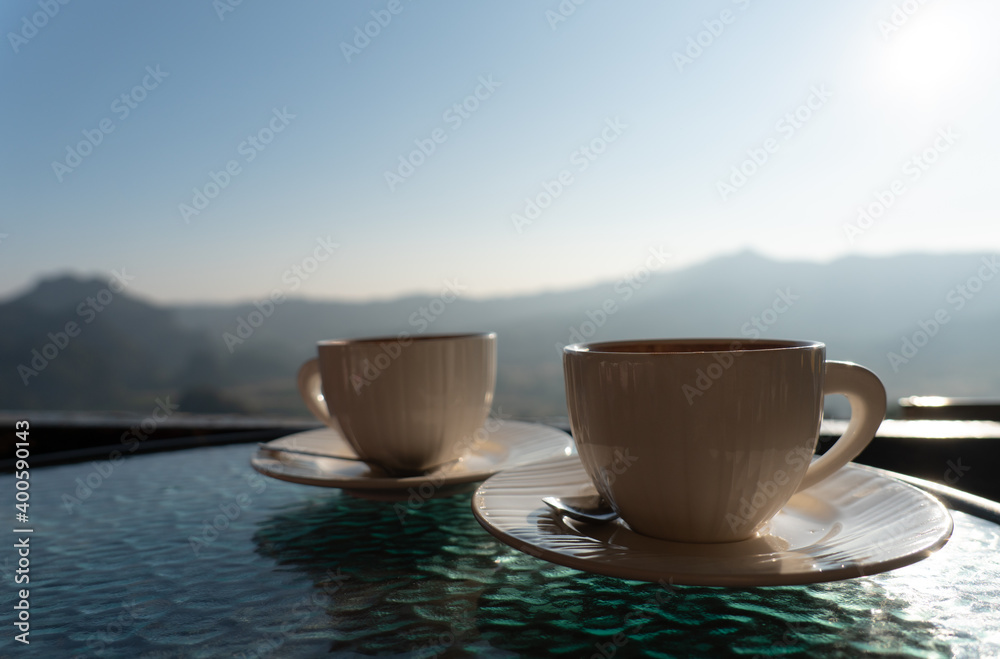 picture of two coffee cup on table with mountain view in morning. couple together and relationship concept