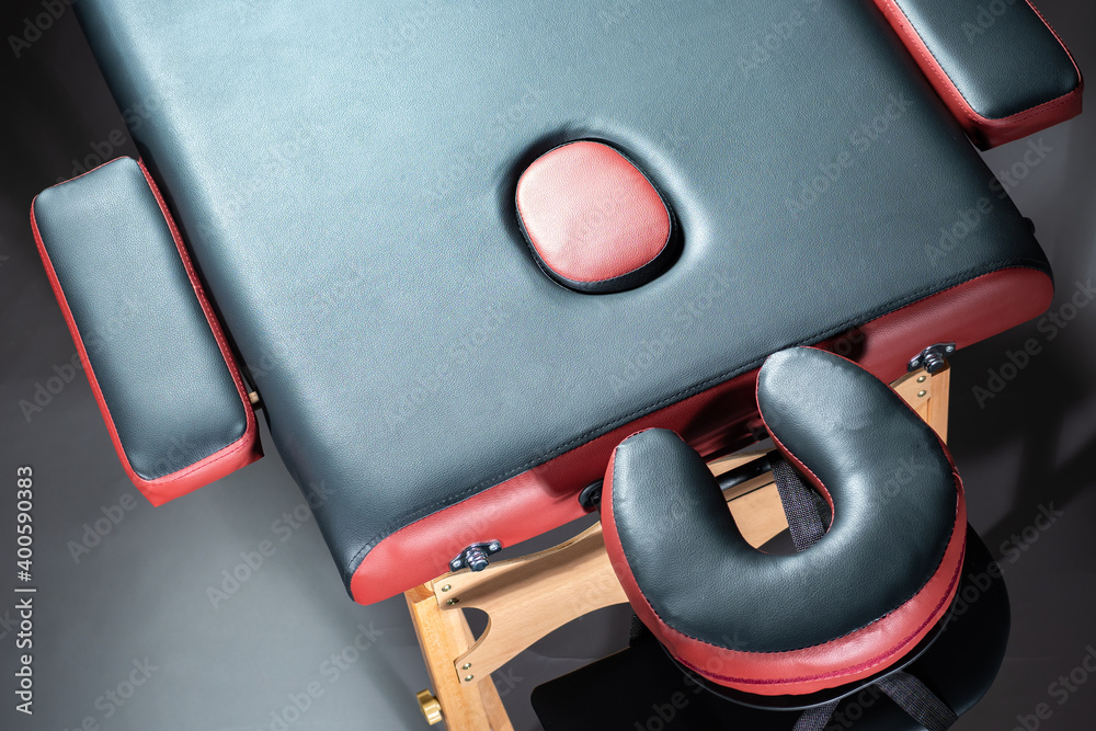 Professional massage table top view. Massage table with rollers for the