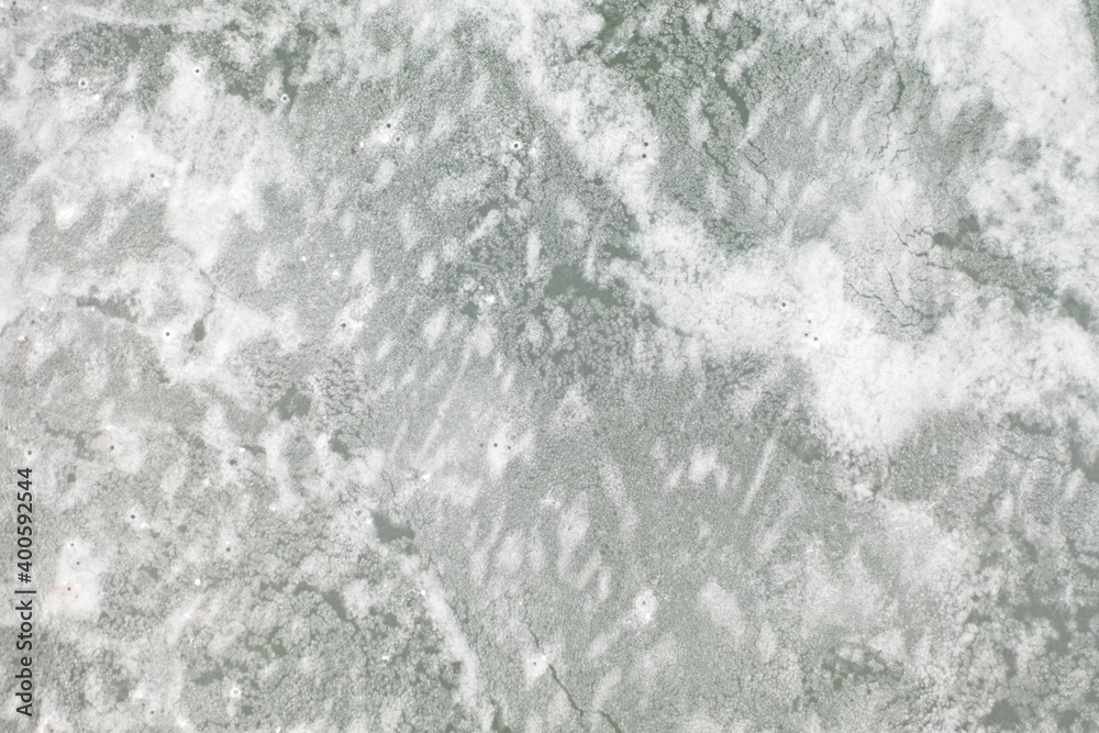 top view of the lake with frozen ice and a beautiful pattern on it