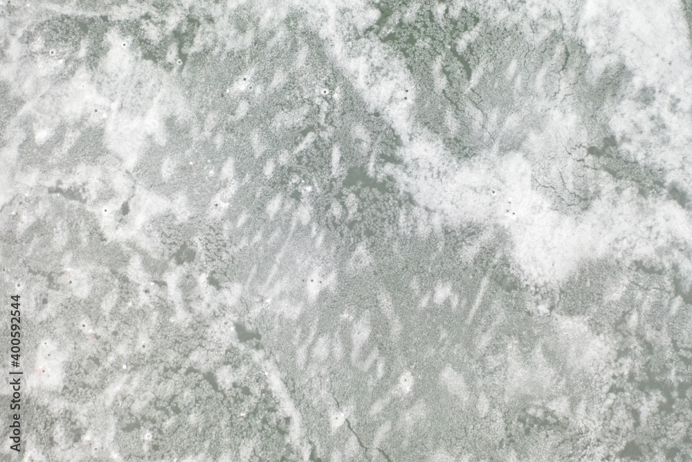 top view of the lake with frozen ice and a beautiful pattern on it top view of the lake with frozen ice and a beautiful pattern on it