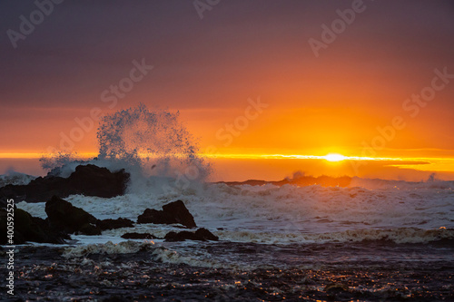 Fototapeta Naklejka Na Ścianę i Meble -  waves break at sunset on north coast northern ireland
