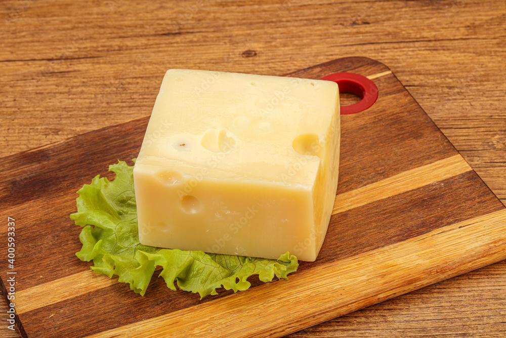 Emmental cheese over wooden board