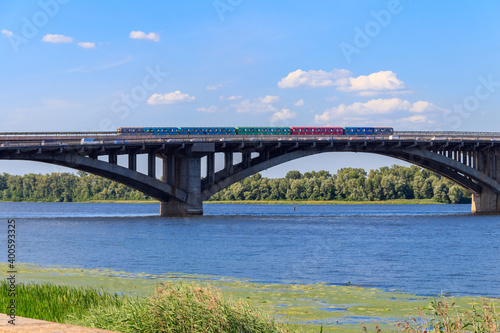 View of Metro bridge with subway train passing and the Dnieper river in Kiev, Ukraine © olyasolodenko