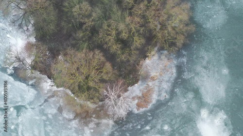 top view of an island in the middle of a frozen lake and fishermen catching fish photo