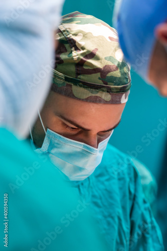 Young military surgeons operating in hospital