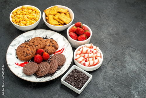front view yummy choco biscuits with different snacks on dark background tea sweet cookie