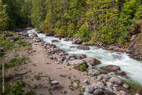 Small mountain creek in Vancouver, Canada. View with mountain background.