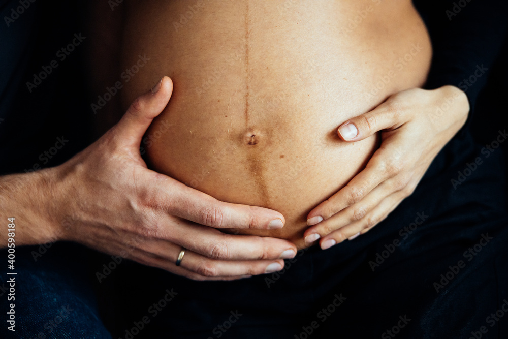 Close up photo shoot of pregnant bump with hands on it. Close up photo shoot of pregnant bump with hands on it.