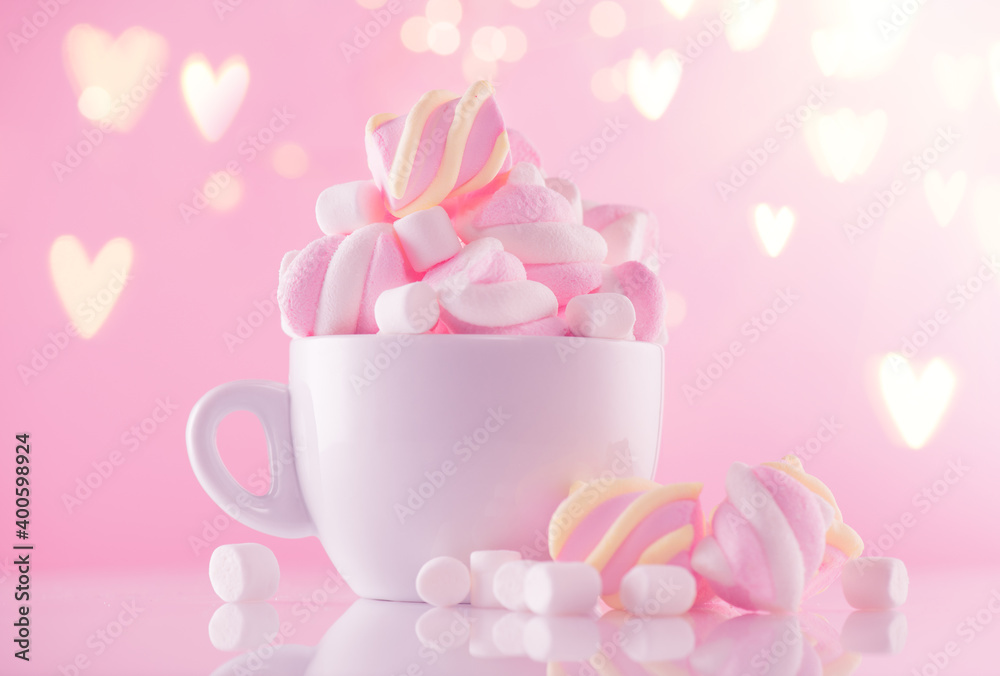Marshmallow. Close-up of Marshmallows colorful chewy candy, over pink bokeh background, closeup. Sweet holiday food dessert in a cup with hot chocolate close-up. Candies. Marshmallow. Close-up of Marshmallows colorful chewy candy, over pink bokeh background, closeup. Sweet holiday food dessert in a cup with hot chocolate close-up. Candies.