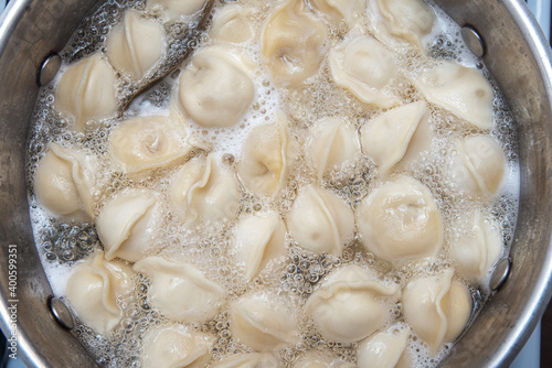 Boiled dumplings or pel'meni in a pan, food picture can use as background