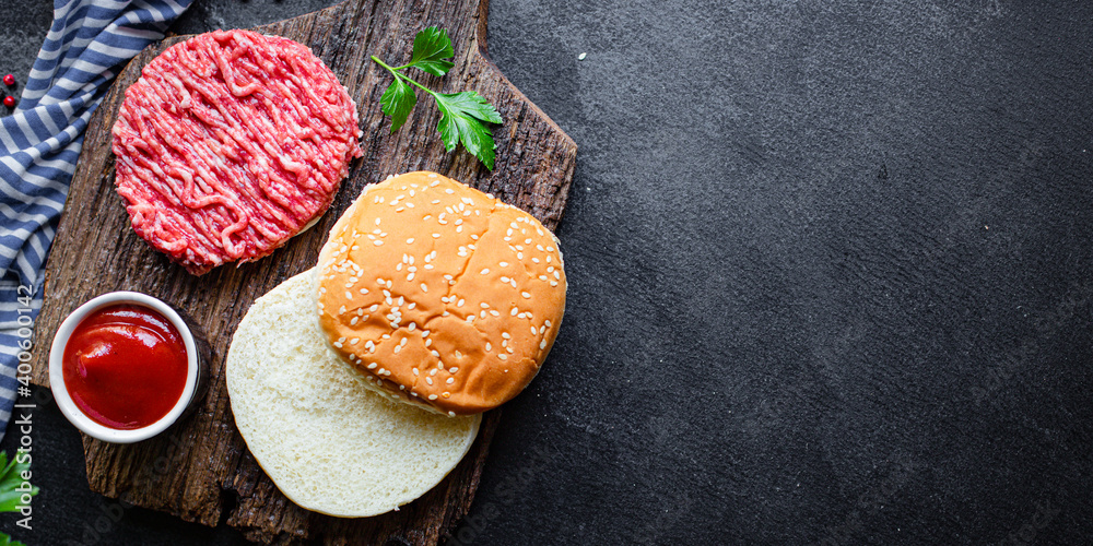 burger raw meat set cutlet, bun bread, tomato sauce and more ready to eat on the table for making meal snack top view copy space for text food background rustic image burger raw meat set cutlet, bun bread, tomato sauce and more ready to eat on the table for making meal snack top view copy space for text food background rustic image