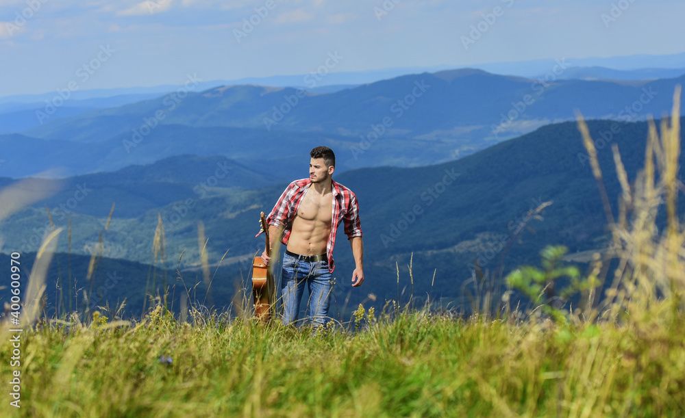 Carefree wanderer. Vast expanses. Peaceful hiker. Conquer the peaks. Man hiker with guitar walking on top of mountain. Guy hiker enjoy pure nature. Musician hiker find inspiration in mountains