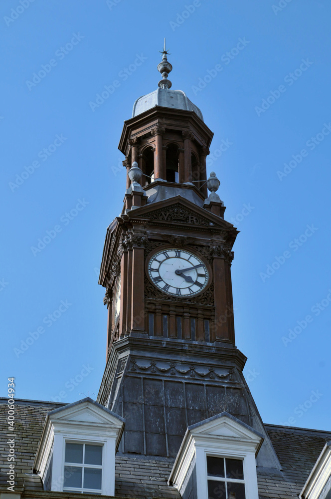 close up of the dome and clock tower of leeds city hall in west yorkshire against a blue sky