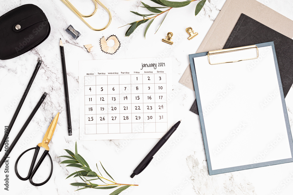 Desktop with calendar for january and office supplies. Home office, social media blog, schedule, planning concept. Flat lay, top view - obrazy, fototapety, plakaty 