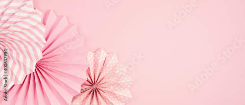 Festive party banner background with pink paper circle fans over pastel background. Festival, birthday, baby shower decoration