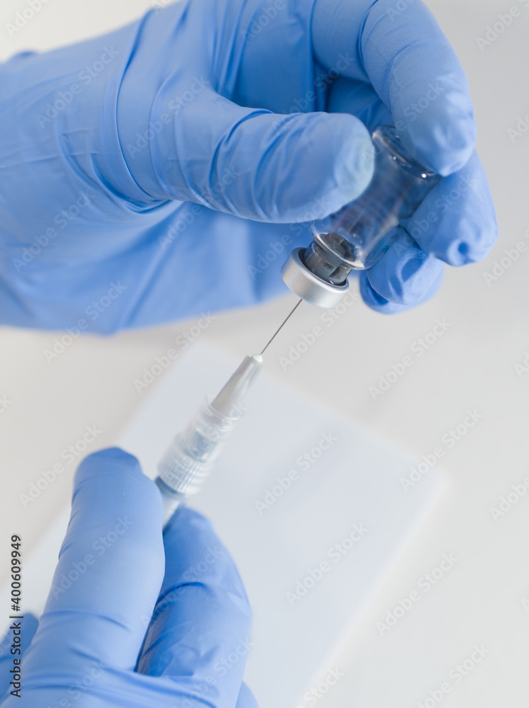 Hands Holding Syringe and Vial Hands Holding Syringe and Vial