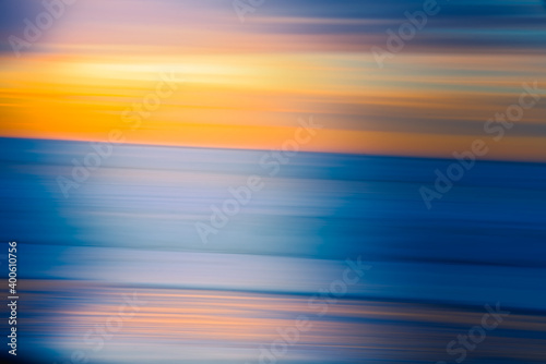Abstract background in bright yellow and blue colors. Sunset over the sea, line art, motion blur