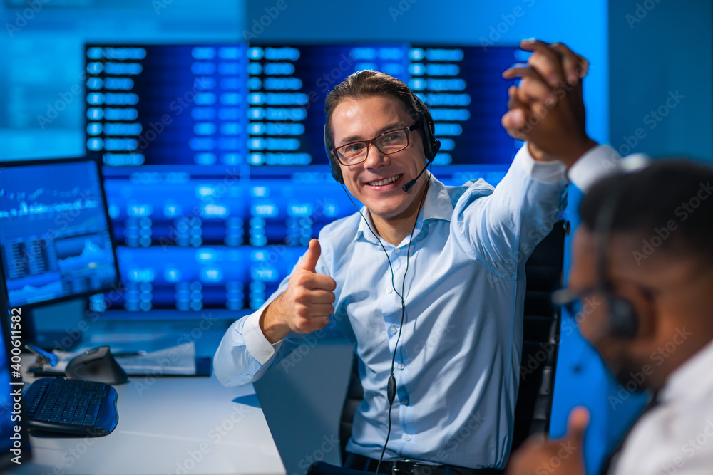 Fototapeta premium Diverse team of brokers workin in office using workstation and analysis technology. Workplace of professional traders. Global financial markets, business strategy, currency exchange and banking concep