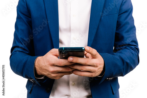 Close-up of the hands of a young man touching the mobile screen on a white background