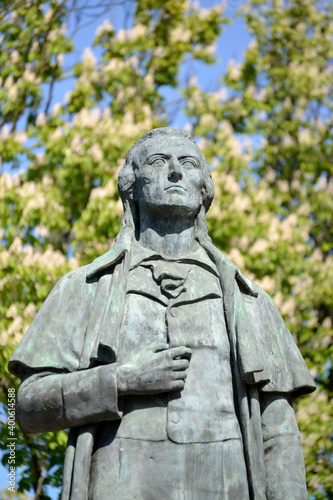 A sculptural portrait of the German poet Friedrich Schiller (1759-1805) against the background of flowering chestnuts. Kaliningrad