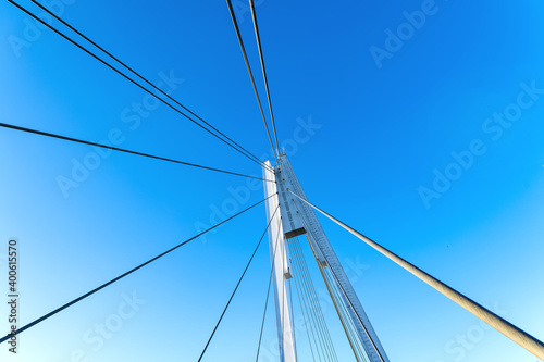 Details of the cable-stayed bridge against the background of the blue sky.