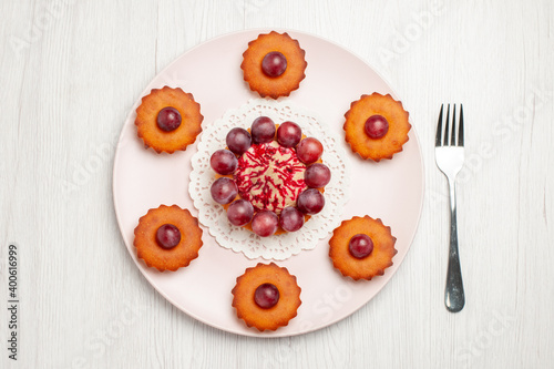 top view delicious cakes with grapes on white background biscuit pie dessert